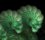 This unusual fractal render resembles a plump green caterpillar, the delicate growth of new ferns, or even a wave cresting. Look closely &mdash; it's edged with baby spirals.